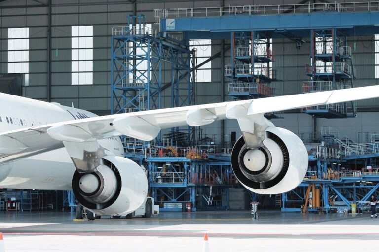 Contemporary airplane in hangar in sunlight