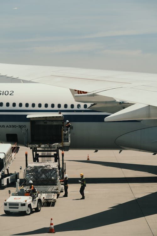 Ground crew loading cargo into an Airbus A330 freighter