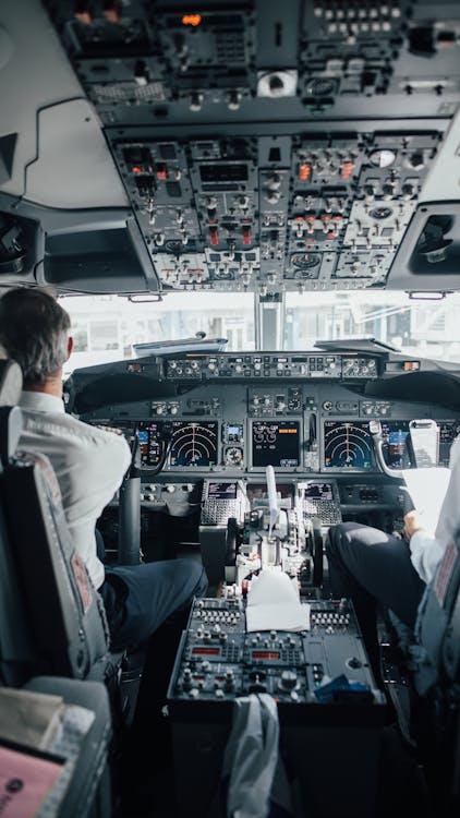 Airbus cockpit with training manuals open on the console