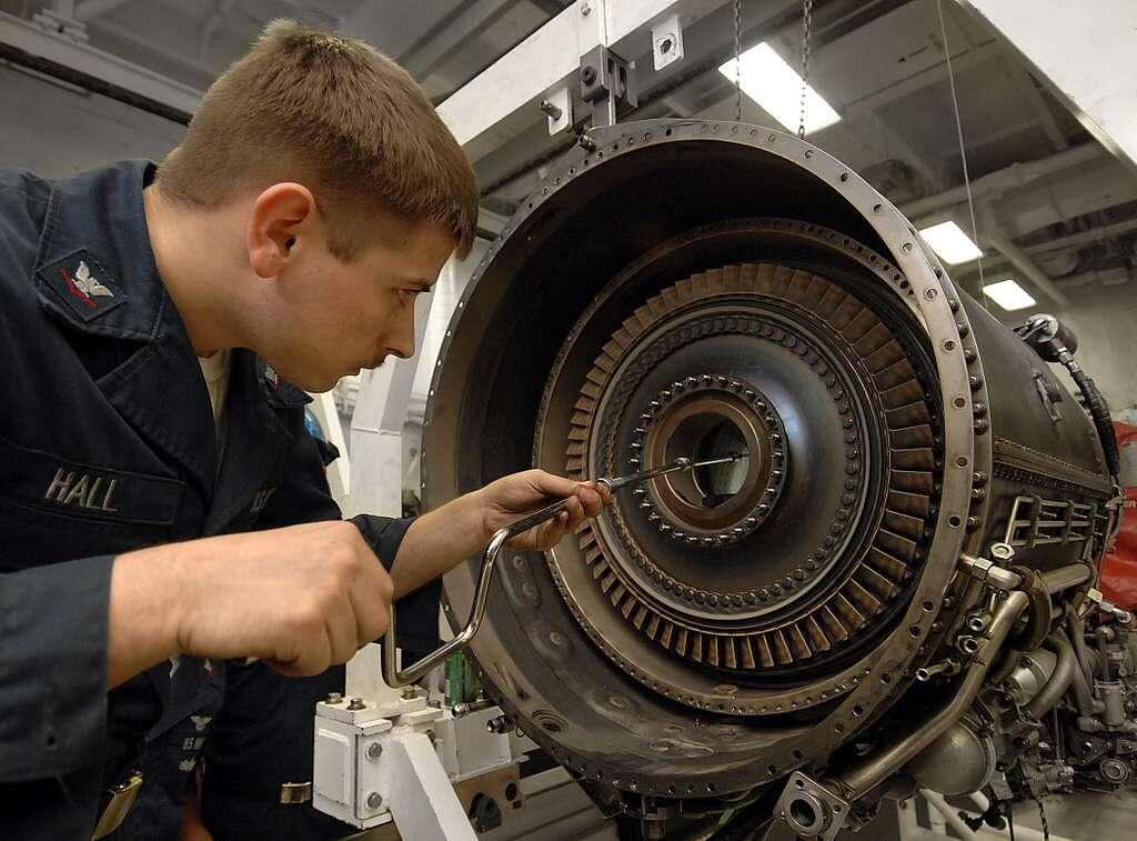 A mechanic working on a jet engine