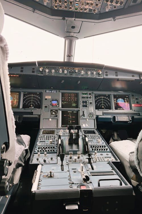 A commercial aircraft cockpit with digital displays
