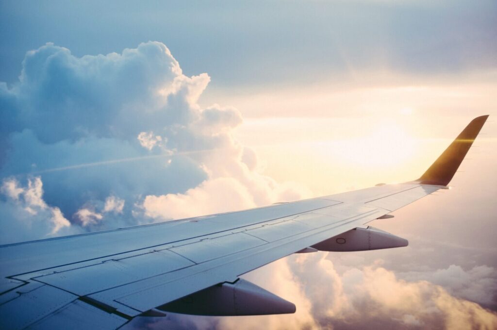 The wing of an airplane in the sky