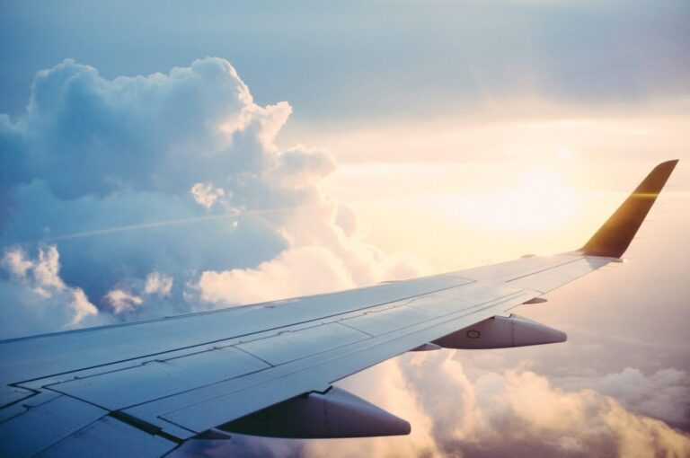 The wing of an airplane in the sky