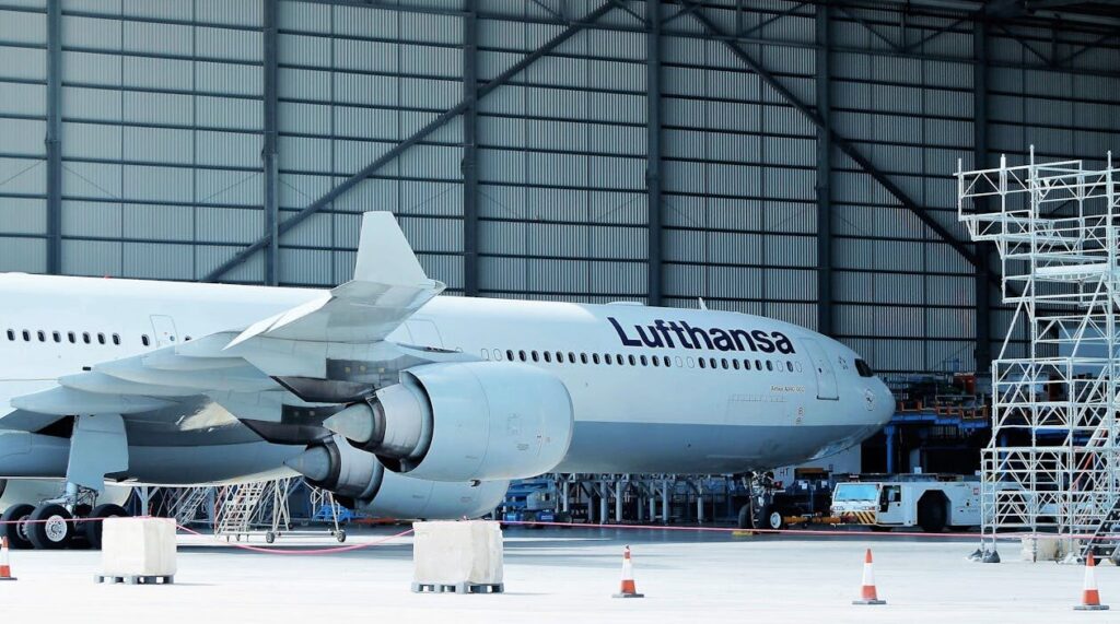 Cargo aircraft being serviced inside an aviation maintenance hangar