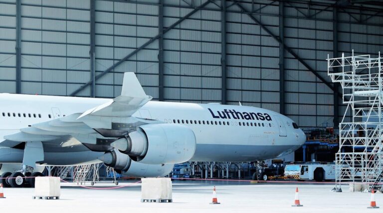 Cargo aircraft being serviced inside an aviation maintenance hangar